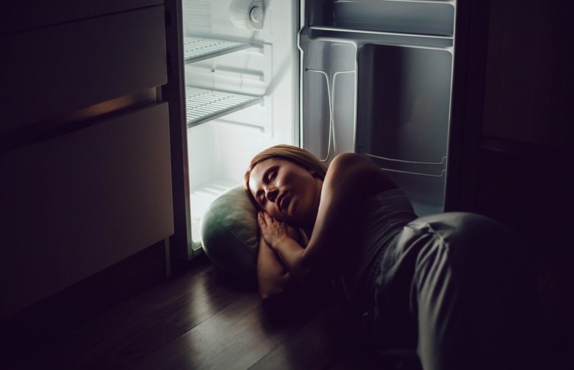 femeie care doarme cu capul în frigider în timpul unui val de căldură